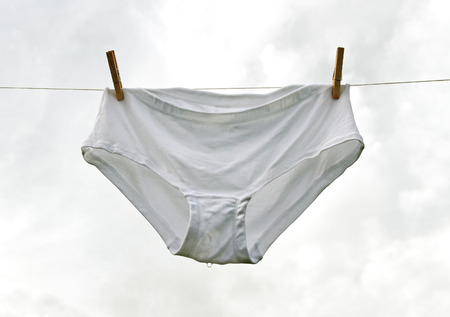 Wet woman`s underwear on the clothes line.の写真素材