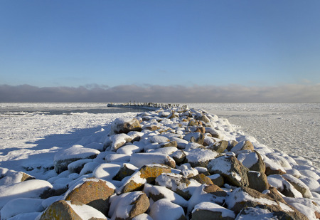 Snowy breakwater in a winter season.の写真素材