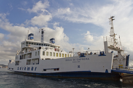 PALAU - SEPTEMBER 22: Harbor for ship in Palau. Big white ship to take tourists to the Maddalena island. Ship on the water on 22 September 2013, Palau, Italy.のeditorial素材