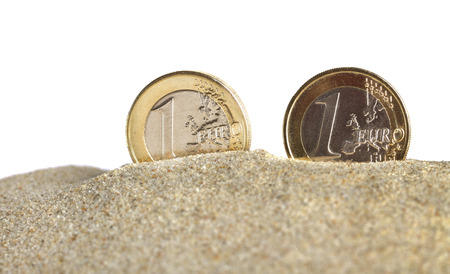 Euro coins on a sand.の写真素材