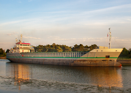 Big ship is going across canal in Liepaja to the Baltic sea.の写真素材