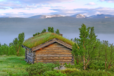 Old traditional house in Norway with grass on a roof.の写真素材
