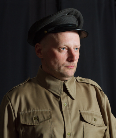 Man in retro uniform on a black surface.の写真素材