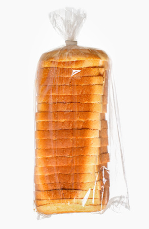 Sliced bread in a plastic bag on white surface.の写真素材