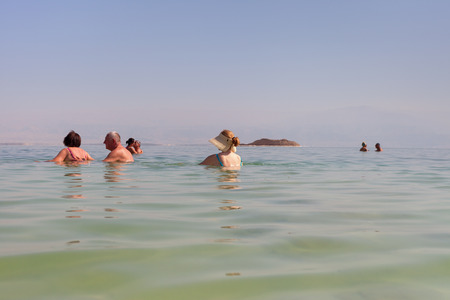 ISRAEL, DEAD SEA - OCTOBER 31: The Dead Sea is a salt lake bordered by Jordan to the east and Israel and Palestine to the west. It was one of the world's first health resorts. Relax at the Dead sea on 31 October 2016.のeditorial素材