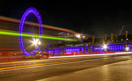 LONDON - OCTOBER 15: Night view of London Eye,which is the tallest ferris wheel in Europe, along the bank of the Thames River on October15, 2011 in London.のeditorial素材