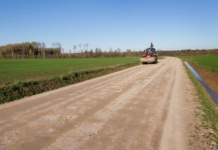 Big tractor on country road.
