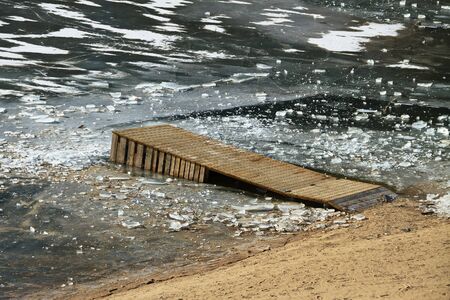 Fishing footbridge on lake in a winter.の写真素材