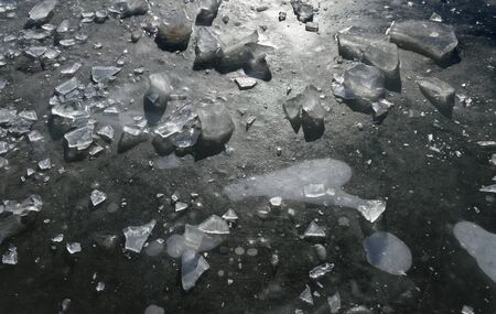 Cracked and blistered ice on the lake.の写真素材