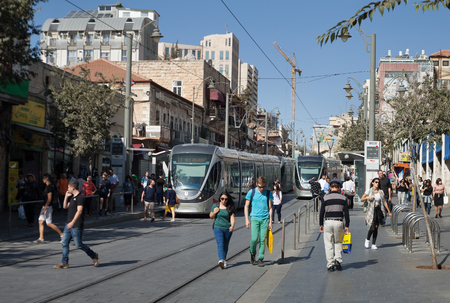 ISRAEL, JERUSALEM - OCTOBER 30: Jerusalem is one of the oldest cities in the world. Two modern trams goes along the street of Jerusalem on 30 October 2016.のeditorial素材