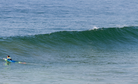 PORTUGAL, ESPINHO - 3 SEPTEMBER: excellent climate and 600 miles of coast, much of which is sandy beach. Young man are surfing on 3 September 2016, Espinho, Portugal.のeditorial素材