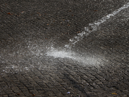 Wet cleaning of street with pressurized water.の写真素材