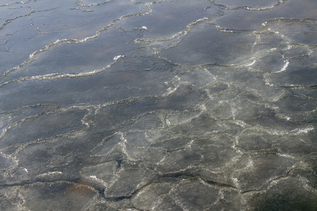 Beautiful and dangerous surface of snow sludge on water.