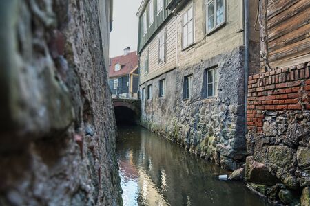 River between houses in old town of Kuldiga, Latvia.
