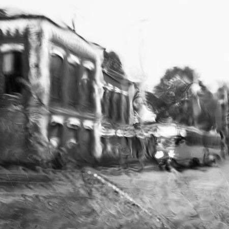 Blurry view of a tram in rain.