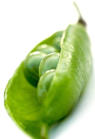 Pod with fresh green peas on white background.の写真素材