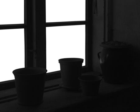 Old pots on windowsill indoor.の写真素材