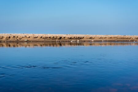 Small river flowing along a coast of Baltic sea.