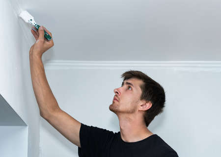 Professional painter restoring a wall.