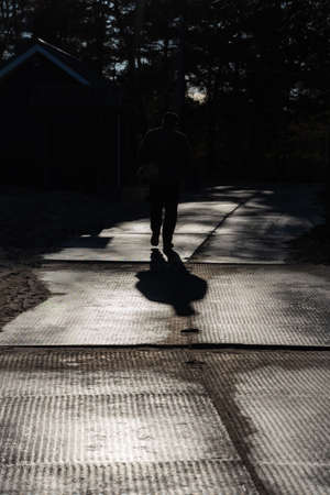 Silhouette of man on the path.
