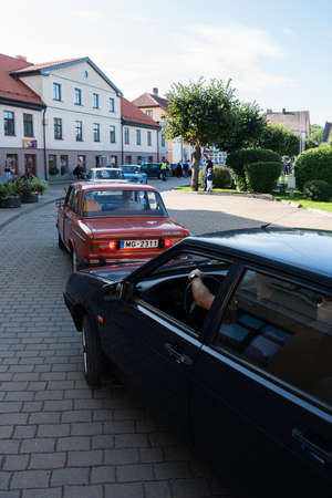LATVIA, SALDUS - 19 SEPTEMBER: Saldus is a Latvian town. Along the city runs the RigaâLiepÄja highway. View to the street with old fashioned cars parade on 19 September 2020, Saldus, Latvia.のeditorial素材