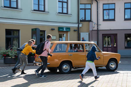 LATVIA, SALDUS - 19 SEPTEMBER: Saldus is a Latvian town. Along the city runs the RigaâLiepÄja highway. View to the street with old fashioned cars parade on 19 September 2020, Saldus, Latvia.のeditorial素材