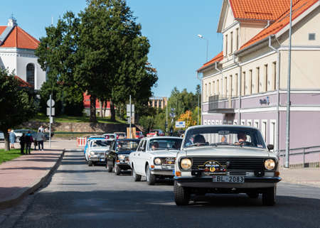 LATVIA, SALDUS - 19 SEPTEMBER: Saldus is a Latvian town. Along the city runs the RigaâLiepÄja highway. View to the street with old fashioned cars parade on 19 September 2020, Saldus, Latvia.のeditorial素材