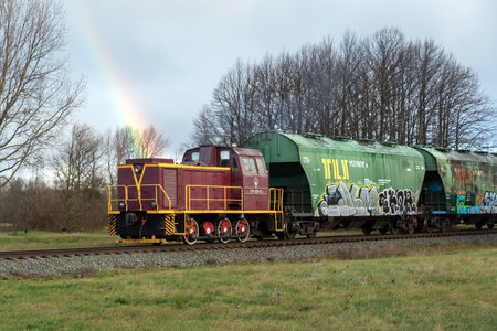 LATVIA, LIEPAJA - 27 NOVEMBER: Liepaja is a Latvian town. Along the city runs the RigaâLiepÄja railroad. View to the train with rainbow over locomotive on 27 November 2020, Liepaja, Latvia.のeditorial素材