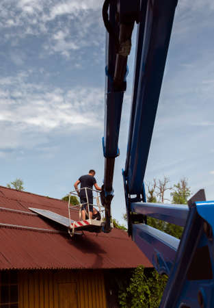 Montage of solar panel on a roof top.の写真素材