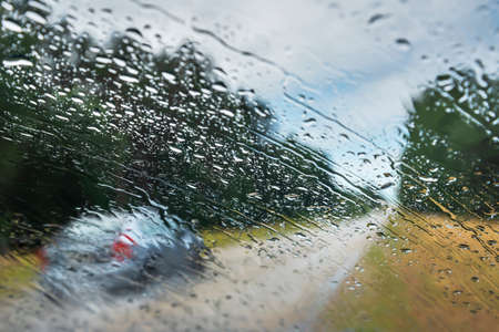 View to road through car window in rainy day.の写真素材