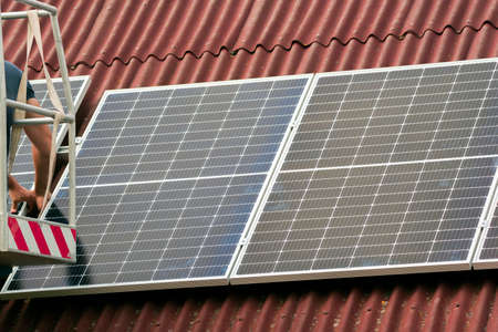 Montage of solar panel on a roof top.
