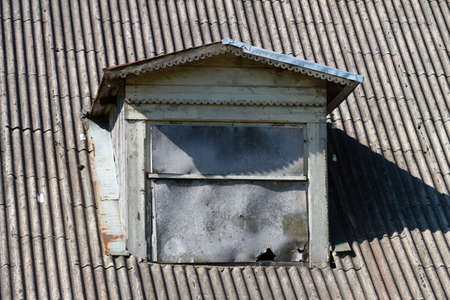 Old window of attic on the roof.の写真素材