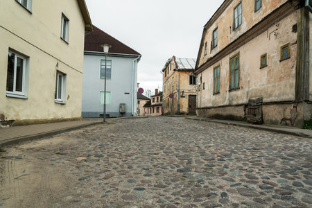View to a street in small town with cobblestone road.の写真素材