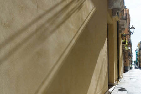 Natural diagonal lines of light and shadow on a wall in Trapani, Sicily.の写真素材