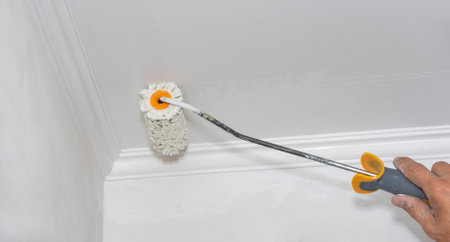 The contractor is repairing the wall in the house.の写真素材