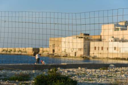 A view of the Trapani coast through a metal fence.の写真素材