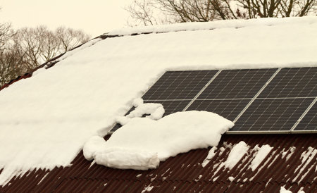 Solar panels on the roof in a winter time.の写真素材