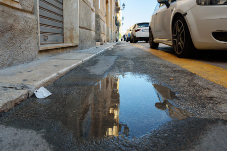 View of a natural street in Trapani with a puddle.のeditorial素材