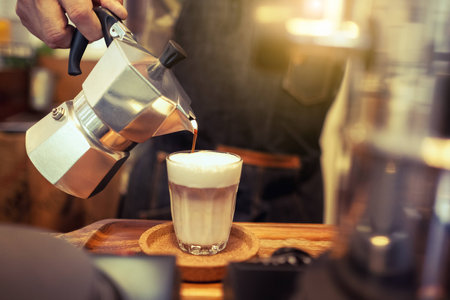 the man pouring aroma coffee with moka pot show classic life styleの写真素材