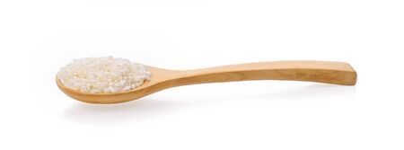 Japanese rice in a wooden spoon on white background.の写真素材