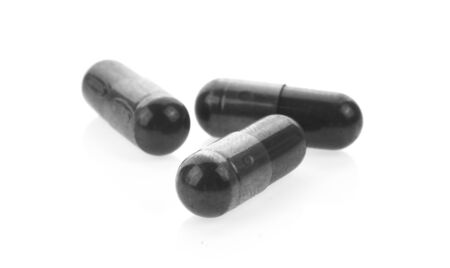 Charcoal capsules on white background.の写真素材