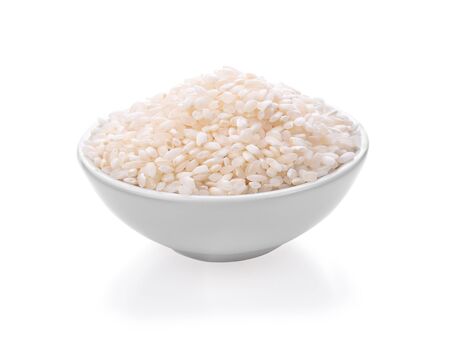 white rice in bowl on white backgroundの写真素材