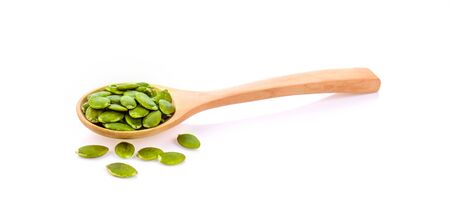 pumpkin seeds in the spoon on white backgroundの写真素材
