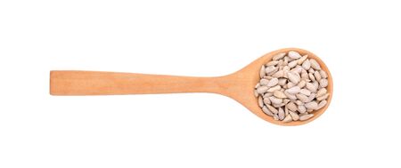 sunflower seeds in wooden spoon on white background.の写真素材