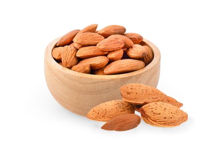 almonds in their skins and peeled with leaf on white background.の写真素材