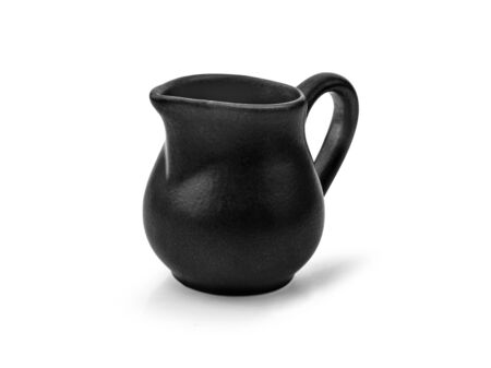 black small ceramic pitcher on white background.の写真素材