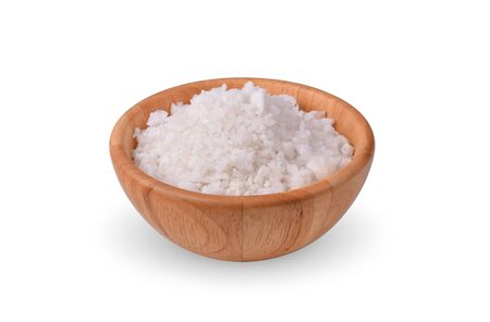 salt in a wooden bowl on white background.の写真素材
