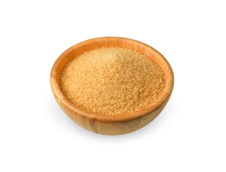 Brown refined sugar in wooden bowl on white background.の写真素材