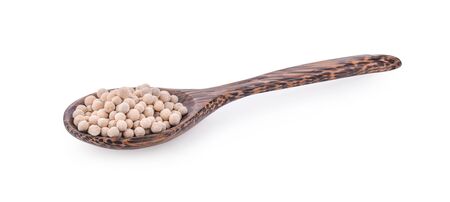 white Pepper seeds in wooden spoon on white background.の写真素材