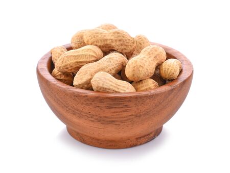 peanuts in wooden bowl on white background.の写真素材